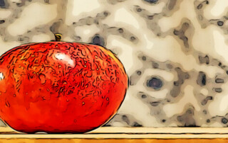 A red apple sitting on top of a table.